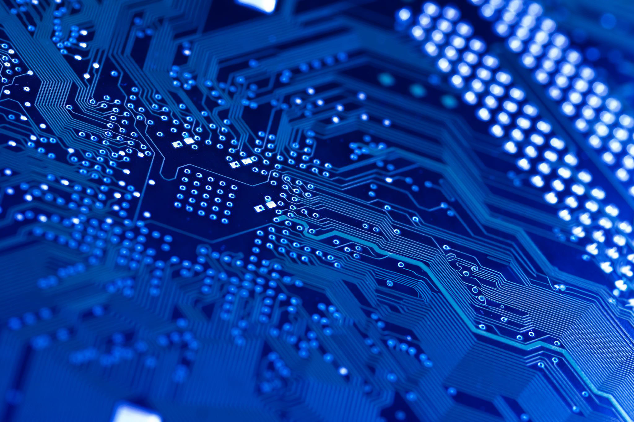 Computer circuit board in blue. Shallow DOF on diagonal.